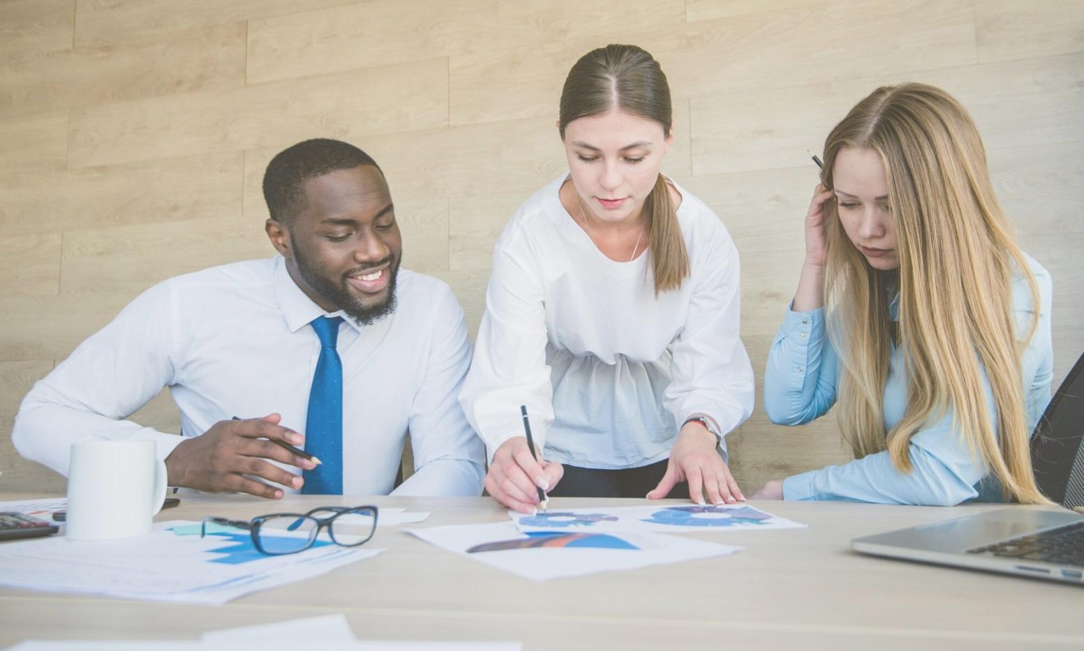Business professionals analyzing financial data during workshop